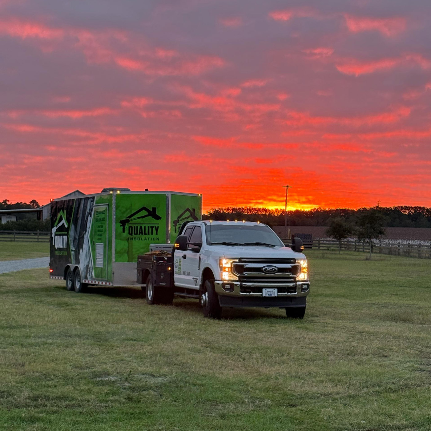Quality Insulation truck on a grass field during sunset