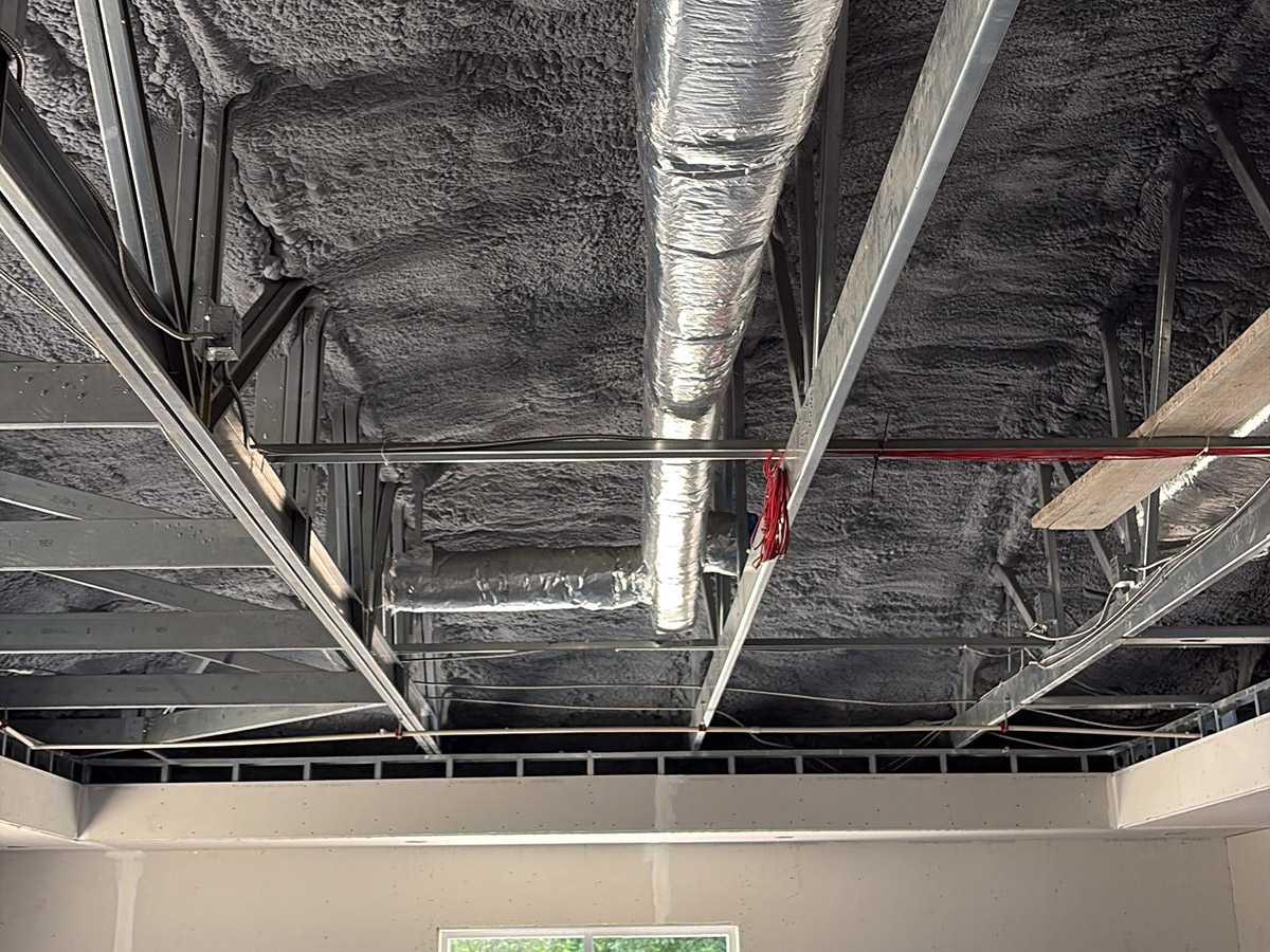 Wakulla-Library-Estes-homes-and-construction-Crawfordville-F-2 Open-cell spray foam insulation applied around HVAC ductwork in the ceiling of the Wakulla Library commercial project.
