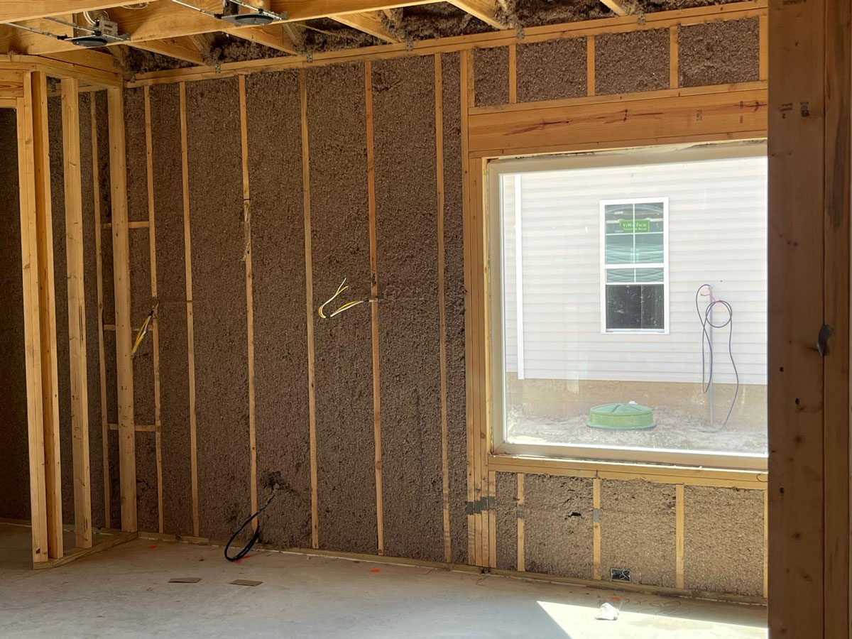 cellulose-wall-spray-3 Dense-pack cellulose insulation installed in wall cavities to improve energy efficiency, sound control, and year-round comfort.