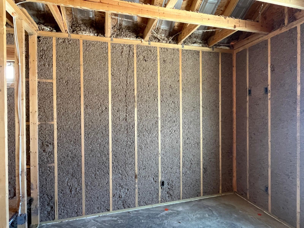 cellulose-wall-spray-4 Dense-pack cellulose insulation installed in wall cavities to improve energy efficiency, sound control, and year-round comfort.