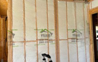Johns Manville Spider Plus behind Quality Insulation branded netting on a full wall in a new home.