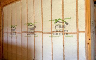 Close-up of Quality Insulation branded netting over Johns Manville Spider Plus in wall cavities.