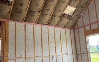 Johns Manville Spider Plus in wall cavities below kraft-faced batts in the vaulted ceiling of a new home.