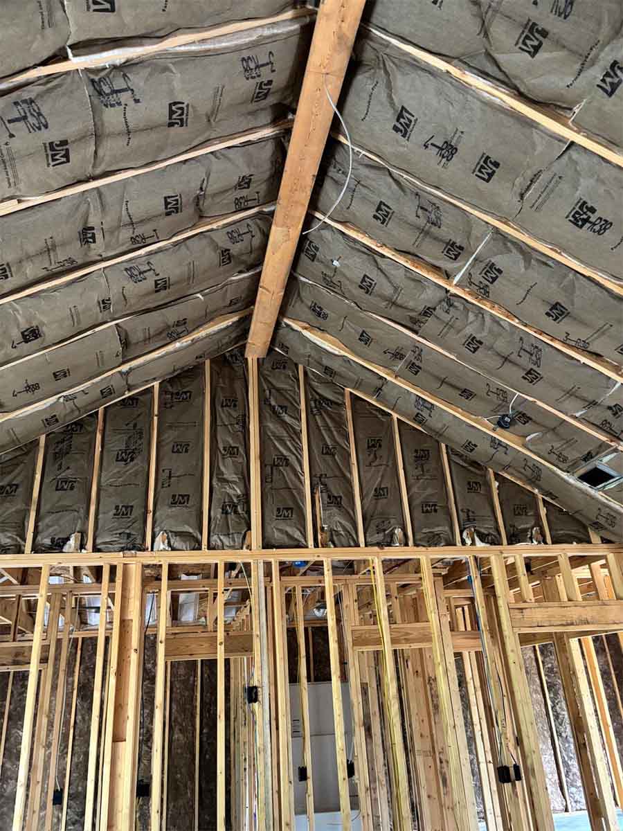Quality Insulation of Valdosta installed kraft-faced R-38 fiberglass batts between vaulted ceiling rafters below the ridge beam in Hahira, GA.