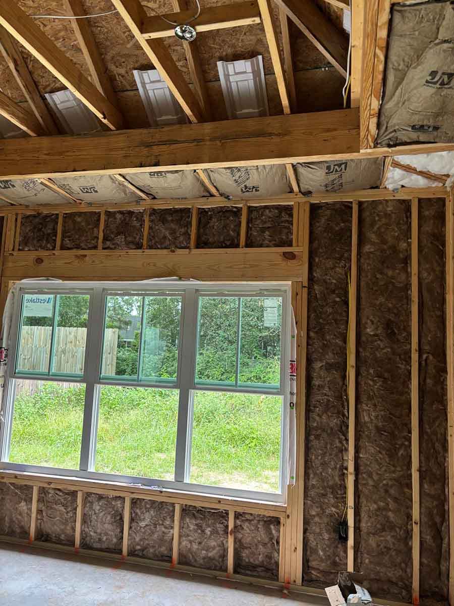 Quality Insulation of Valdosta installed fiberglass batts in wall cavities above and below a window in a new home in Hahira, GA.
