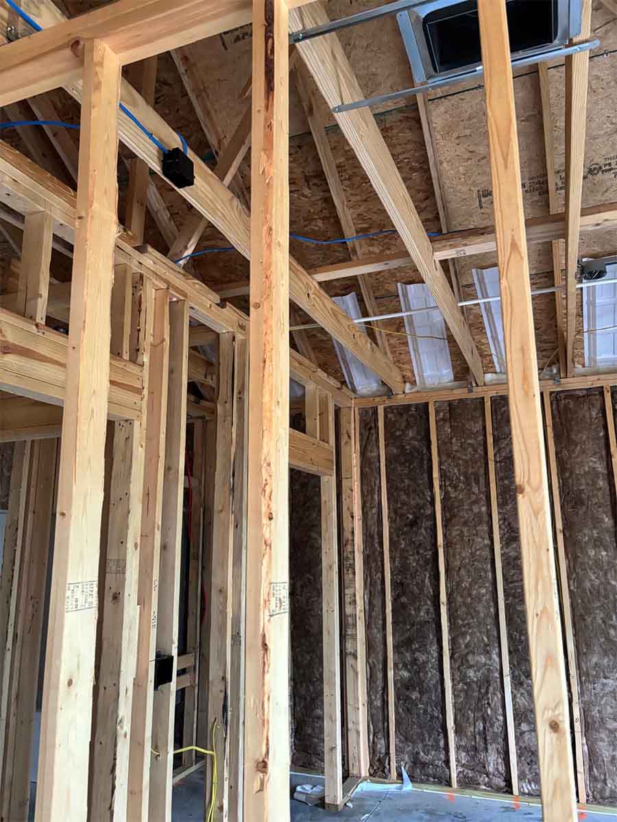 Quality Insulation of Valdosta installed fiberglass batts in exterior wall cavities behind open interior framing in a new home in Hahira, GA.